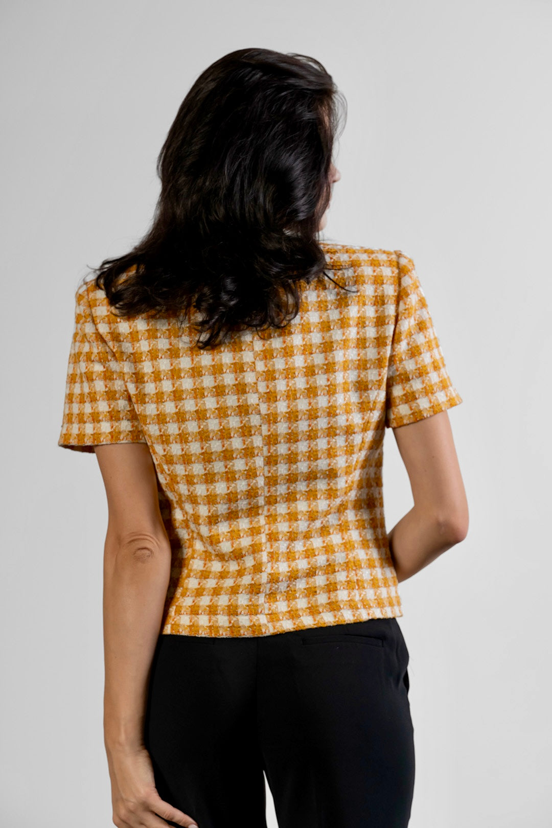 Toni flared trousers in black by Sofia Lara — back view, worn with the Niya jacket
